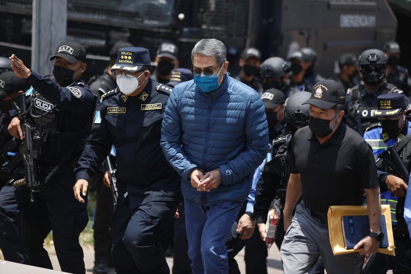 Policías hondureños escoltan a Juan Orlando Hernández para su extradición desde Tegucigalpa, Honduras, el 21 de abril. Fotógrafo: Tomas Ayuso/Bloomberg